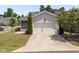Charming home featuring a two-car garage, screened-in porch, and lush landscaping at 1000 Groveview Wynd, Wendell, NC 27591