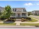Inviting curb appeal with landscaped front yard, covered porch, dormer windows and street view at 1000 Groveview Wynd, Wendell, NC 27591