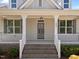 Close up view of front porch with brick stairs, white columns and the house number 1000 at 1000 Groveview Wynd, Wendell, NC 27591