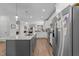 This modern kitchen is complete with an island, granite counters, and stainless appliances at 1000 Groveview Wynd, Wendell, NC 27591