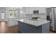 Modern kitchen featuring a large island, stainless steel appliances, and hardwood flooring at 1000 Groveview Wynd, Wendell, NC 27591