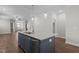 Stylish kitchen island with stainless steel sink, granite countertops and hardwood flooring at 1000 Groveview Wynd, Wendell, NC 27591