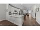 This open-concept kitchen has stone countertops, stainless appliances, and two islands at 1000 Groveview Wynd, Wendell, NC 27591