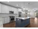 Open kitchen with a center island, stainless steel appliances, and lots of light at 1000 Groveview Wynd, Wendell, NC 27591