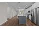 Bright, open-concept kitchen featuring stainless steel appliances and a spacious center island at 1000 Groveview Wynd, Wendell, NC 27591
