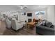 This open living room has hardwood floors, a ceiling fan and fireplace with mounted TV at 1000 Groveview Wynd, Wendell, NC 27591