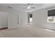 Spacious main bedroom featuring plush carpet, ceiling fan, and natural light from two windows at 1000 Groveview Wynd, Wendell, NC 27591