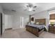 This bright main bedroom has plush carpet, a ceiling fan, and an adjoining bathroom at 1000 Groveview Wynd, Wendell, NC 27591