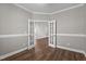 Bright home office with glass french doors and luxury vinyl plank flooring at 1000 Groveview Wynd, Wendell, NC 27591