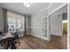 Office space with wood-look flooring, large window, and adjacent room through glass door at 1000 Groveview Wynd, Wendell, NC 27591