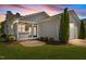Rear exterior view showcasing a screened-in porch and well-maintained lawn at 1000 Groveview Wynd, Wendell, NC 27591