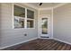 Cozy screened porch with wood floors and an exterior view of the side of the home at 1000 Groveview Wynd, Wendell, NC 27591