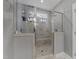 Modern, tiled glass shower features dual shower heads, a small window, and a built-in bench at 1000 Groveview Wynd, Wendell, NC 27591