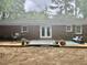 Back exterior of brick house with a wooden deck, elegant French doors, and delightful potted flowers at 1006 Aversboro Rd, Garner, NC 27529