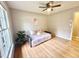 Bright bedroom with hardwood floors, a ceiling fan, a window, and a cozy daybed with decorative pillows at 1006 Aversboro Rd, Garner, NC 27529