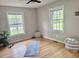 Bright and airy room with hardwood floors, two windows, and a yoga mat at 1006 Aversboro Rd, Garner, NC 27529