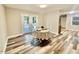 Bright dining area with updated flooring and natural light from the exterior doors at 1006 Aversboro Rd, Garner, NC 27529