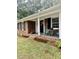 Inviting brick home with a covered porch featuring colorful flowers and seating at 1006 Aversboro Rd, Garner, NC 27529
