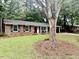 Well-maintained single-story brick home featuring a manicured front lawn and a covered entrance at 1006 Aversboro Rd, Garner, NC 27529