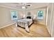 Cozy main bedroom with hardwood floors, ceiling fan and two windows at 1006 Aversboro Rd, Garner, NC 27529