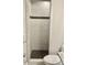 Elegant shower stall features white tile walls with a decorative accent strip and a black tiled floor at 1006 Aversboro Rd, Garner, NC 27529