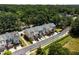 Aerial view of townhomes with garages, wooden decks, surrounding trees, and landscaping at 1017 Frank Page Dr, Cary, NC 27511