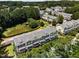 Aerial view of a townhome community with surrounding trees and a nearby pond at 1017 Frank Page Dr, Cary, NC 27511
