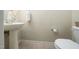 A quaint powder room with a pedestal sink, neutral wall color, and a standard white toilet is nearby at 1017 Frank Page Dr, Cary, NC 27511