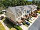 Charming townhome exterior shows private decks and parking for each unit and lush landscaping at 1017 Frank Page Dr, Cary, NC 27511