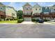 Townhome exterior featuring a two-car garage, brown brick, and a wooden deck at 1017 Frank Page Dr, Cary, NC 27511