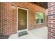 Brick porch with a brown door and window is adjacent to a wall at 1017 Frank Page Dr, Cary, NC 27511
