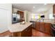 Spacious kitchen seamlessly connected to the living area features stainless steel appliances and a granite island at 1017 Frank Page Dr, Cary, NC 27511