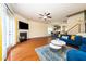 Cozy living room with fireplace, hardwood floors, and access to the kitchen and dining area at 1017 Frank Page Dr, Cary, NC 27511