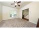 Inviting living room features neutral carpet, a large window, and staircase at 1017 Frank Page Dr, Cary, NC 27511