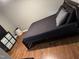 Bedroom with hardwood floors, a black bed frame, grey bedding, dresser, and ample closet space at 104 Holly Ranch Ct, Willow Springs, NC 27592