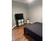 Bedroom features hardwood floors, minimal furnishings, and a television on a storage unit at 104 Holly Ranch Ct, Willow Springs, NC 27592