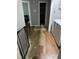 Hallway with laundry area and access to other rooms, featuring damaged laminate flooring at 104 Holly Ranch Ct, Willow Springs, NC 27592