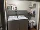 Laundry room equipped with a washer, dryer, and shelving for storage at 104 Holly Ranch Ct, Willow Springs, NC 27592