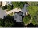 Aerial view of the home with a gray roof surrounded by green trees and a circular driveway at 104 Shady Ridge Ct, Apex, NC 27502