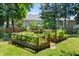 A backyard featuring raised garden beds and lush greenery. Perfect for outdoor relaxation and gardening at 104 Shady Ridge Ct, Apex, NC 27502