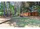 A spacious backyard features a fire pit and mature trees. Perfect for Gathering and entertaining at 104 Shady Ridge Ct, Apex, NC 27502
