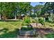 A backyard features raised garden beds surrounded by lush greenery. Perfect for gardening enthusiasts at 104 Shady Ridge Ct, Apex, NC 27502