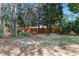 Secluded backyard featuring a cozy fire pit area with a swing and a decorative pergola at 104 Shady Ridge Ct, Apex, NC 27502