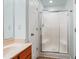 Bathroom vanity with wood cabinets and walk-in shower with glass door at 104 Shady Ridge Ct, Apex, NC 27502