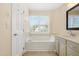 Bright bathroom featuring a bathtub with window views, complemented by neutral tones and ample space at 104 Shady Ridge Ct, Apex, NC 27502