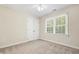 Bedroom with neutral carpet, a window, and a double-door closet, creating a tranquil retreat at 104 Shady Ridge Ct, Apex, NC 27502