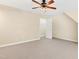 A vacant bedroom featuring neutral walls, carpet, a ceiling fan, and multiple windows at 104 Shady Ridge Ct, Apex, NC 27502