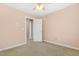 Neutral-toned bedroom with a window and door leading to the hallway at 104 Shady Ridge Ct, Apex, NC 27502