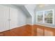 Cozy bedroom with hardwood floors, closet, large window, and ceiling fan at 104 Shady Ridge Ct, Apex, NC 27502