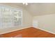 Cozy bedroom with hardwood floors, natural light from a window and a door to a small closet at 104 Shady Ridge Ct, Apex, NC 27502